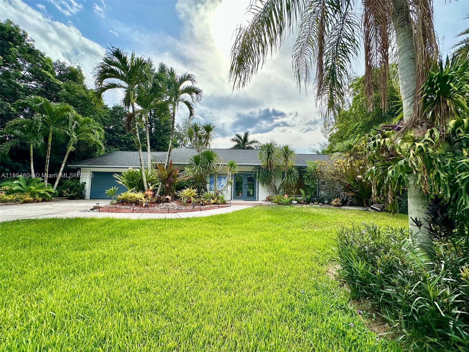 Stunning Furnished 3BR/3BA Home in Davie.
Beautifully appointed residence featuring an open-concept layout with designer furnishings and high-end finishes throughout. The modern kitchen offers granite countertops, stainless steel appliances, and seamless flow into the living and dining areas. The home includes a spacious family room with a dedicated workspace, a serene primary suite with a large walk-in closet, and oversized picture windows that invite abundant natural light and views of the lush, tropical surroundings. Step outside to your private backyard oasis with exotic landscaping, a tranquil pond, and a relaxing Jacuzzi. A rare blend of comfort, style, and tranquility—perfectly located near city amenities yet surrounded by nature. Schedule your private tour today