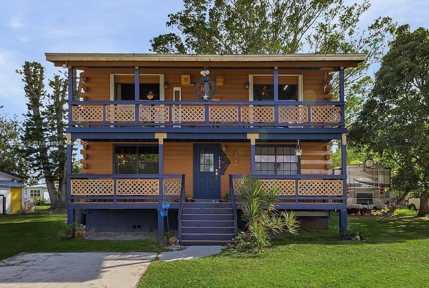 One-of-a-kind furnished log cabin-style home with river views in the heart of Fort Myers! This charming two-story residence features authentic cedar log construction, tongue-and-groove wood interiors, and warm rustic character throughout. Upstairs offers two bedrooms that open to a shared balcony with views of the Caloosahatchee River. Downstairs includes a spacious living area and a half bath that was previously a full bath—easily convertible. Metal roof provides long-term durability and potential insurance savings. Situated on a generous 10,106 sq ft lot with no HOA—plenty of room for RVs, boats, or a pool. Located in Rainbow Groves, minutes to downtown. Move-in ready, this home is ideal as a unique primary residence, vacation getaway, or Airbnb-style rental.
