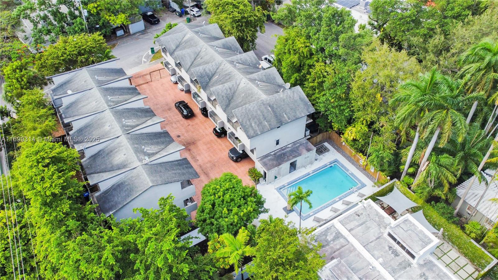 Discover luxury living in this exquisite two-story townhouse nestled in Coconut Grove. This corner unit has passed its 40-year re-certification inspection, ensuring quality and peace of mind. It features covered parking for two cars and boasts four balconies with garden views and abundant natural light. The spacious home offers two generously sized bedrooms, two-and-a-half bathrooms, and a backyard perfect for outdoor gatherings. Located near Coconut Grove’s shops and dining, Dinner Key Marina, Cocoa Walk Shops, AMC theaters, and restaurants, it blends tranquility with urban convenience. The condo association's reserves enhance property value and stability, offering a sophisticated lifestyle in a lush tropical setting
