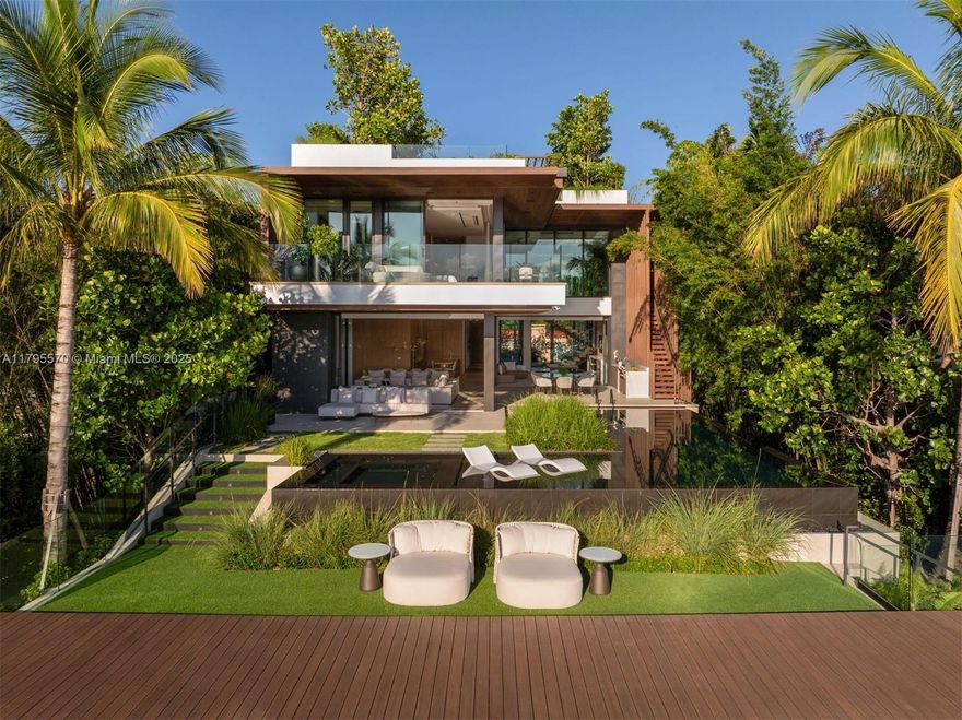 AWARD-WINNING—Maison Rive Gauche, crowned Best Luxury Architecture in Florida for 2025, is a bold waterfront masterpiece by Strang Design, capturing the essence of refined living on the Venetian Islands. Thoughtfully designed with sophistication and attention to detail. A tranquil water garden arrival sets the tone for brilliance. A 22’grand salon wrapped in oak-paneled walls features a bespoke bar, 420-gallon aquarium, and sunset lounge. The Gaggenau kitchen impresses with sculptural oak island and sleek cabinetry. The 1,400 SF primary suite offers dual spa baths, 2 walk-ins, and skyline terrace. 4 ensuite bedrooms, theater, office, elevator, and a panoramic rooftop, designed for comfort and ease, with stunning sunset views, perfect for entertaining. A/C garage, seawall, and 2 boats dock.