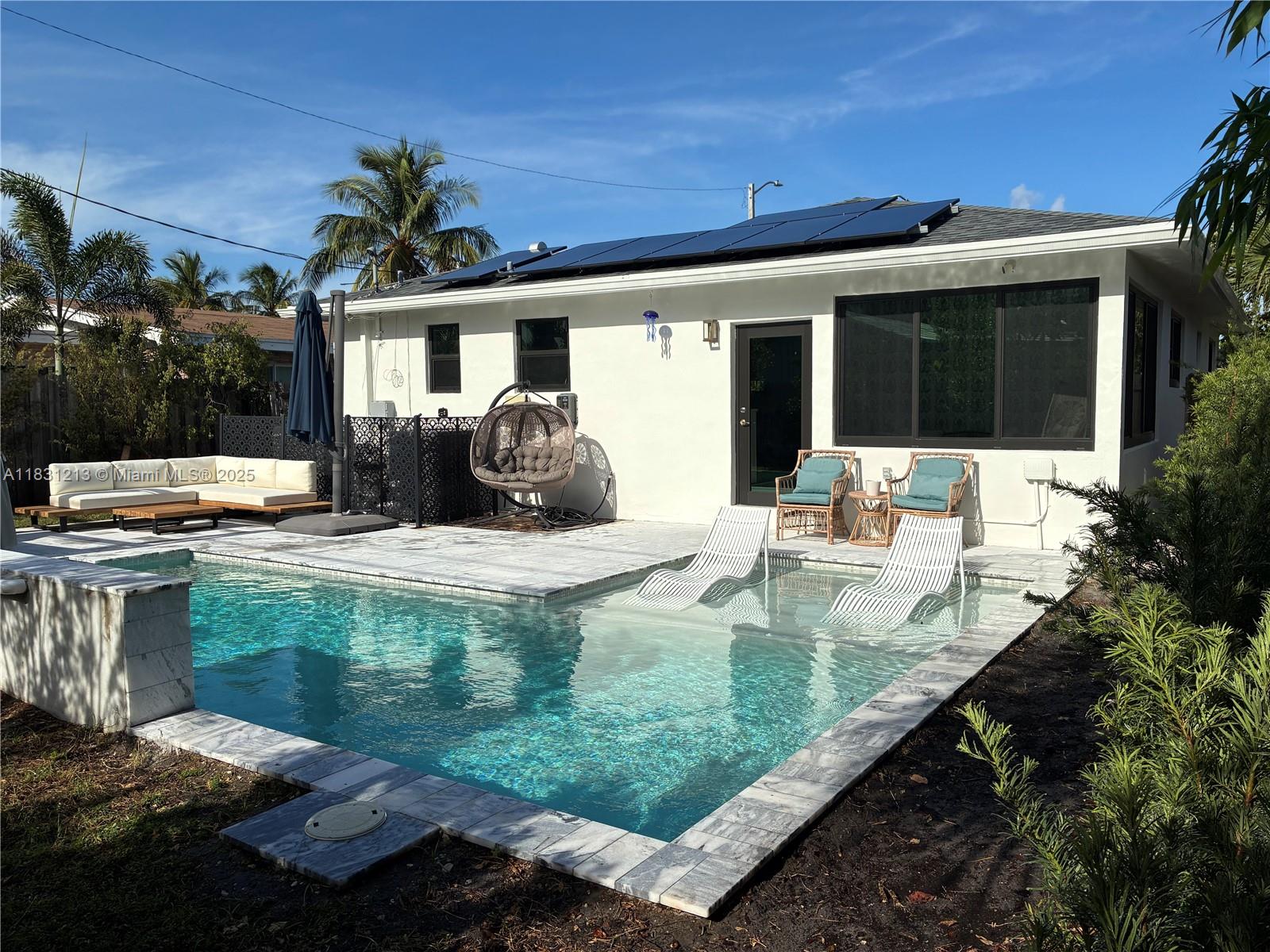 FURNITURE Included. 2023 renovation and NEW POOL. OASIS on earth 0.5 miles from BEACH. Beach Parking and Pool maintenance included. NEW grass and sprinklers System. NEW AC System and modern dashboard. 2 bedrooms, 2 baths, 1 den/familyRoom with pool views, 1 laundry room, and 1 storage attached. Oak hardwood floors. Outstanding kitchen with Fulgor Milano induction range, dishwasher, and fridge. Wolf microwave built in to the island, elegant wood cabinetry and Cambria Quartz counter tops. NEW windows and doors (impact). NEW Pool salt system, HEATER and fountain. Beautiful travertine deck. Updated Electric/plumbing. AND Solar Panels to reduce energy costs by up to 90%. Updated Master bath with tub, Kingston brass fixtures, and Moroccan tile flooring. Beautiful trees, palms and shrubs.