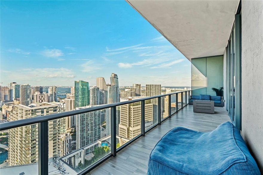 Penthouse 5704 redefines elevated living in the heart of Brickell. Spanning over 2,500 SF + 603 SF of sweeping terrace, this expansive residence offers 3 oversized bedrooms, a den, and 4 full bathrooms, with soaring 12’ ceilings that frame panoramic city, bay, sunrise, and sunset views from every room. One of the largest floorplans, this custom-renovated home exceeds a typical “smart home." Features a private elevator foyer, custom European closets, intelligent bidet toilets with heated seats, custom hardwired motorized Lutron shades, smart dimmers, scene keypads and bespoke finishes. 2 side-by-side parking spaces. Live atop SLS Lux with a private Sky Lounge wine locker and access to luxury amenities: rooftop pools, cabanas, tennis court, cigar room, gym, full-service spa, BBQs and more.