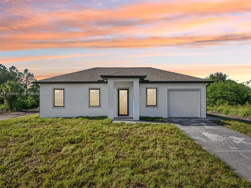 New Construction Home in a fast-growing area of Lehigh Acres! This 3 bed / 3 bath home on a 1/4-acre lot features an open floor plan and porcelain tile floors throughout. The contemporary kitchen boasts beautiful white cabinets, quartz countertops and stainless steel appliances — washer and dryer included. Impact windows and doors, a one-car garage, and a generous yard perfect for outdoor living or a future pool complete this move-in ready package. Modern finishes and thoughtful design make this an exceptional new offering in Lehigh Acres. Seller Willing to give a credit for Closing costs!!