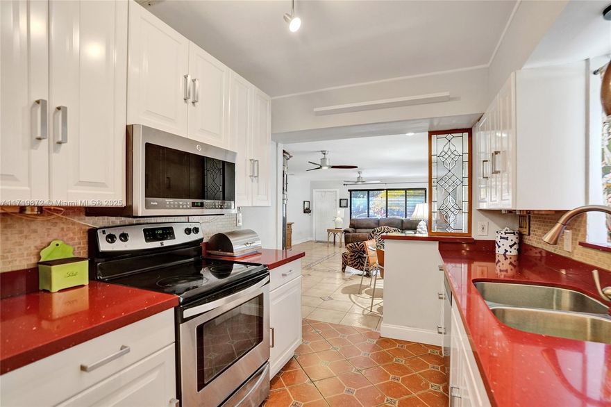 PERFECT AIRBNB! NO FLOOD INS REQ'D Beautiful 2 BR 2 BA, 1 Car garage + a den & office or as a 3rd B/R home located on a quiet tree lined street, 2019 Tile Roof. Hurricane Impact Windows. NO HOA. Fully fenced in Private backyard 6' high vinyl fence with doublewide electric remote doors, perfect to park RV/Boat. Room for a Pool. New Tankless Water Heater. Kitchen features newer appliances, Quartz counter tops. Tile & laminate wood flooring, ceiling fans. Massive backyard, wood pergola and screened sunroom. Garage is accessible via quiet alley in the back of the house, plenty of room in alley to pull in truck, RV, boat thru the double doors into the huge back yard. Great location, only minutes away from both Downtown Hollywood & the beach.  Minutes to Ft Lauderdale & Miami. No flooding