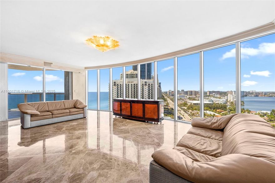Motivated seller! This magnificent 3 bed. 3 1/2 bath. SE corner residence offers one of the best layouts paired with the most amazing panoramic view in South Florida, overlooking the ocean, bay & the City of Sunny Isles. The unit features three bedrooms in-suite with a powder room accessible by private elevator. Many upgrades, incl. marble flooring throughout, custom made high end built-ins with exotic wood, elegant Murano glass light fixtures, electric screens and more. Property offers lots of amenities including: recently renovated pool deck area w/swimming pool, hot tub, spa, tennis courts, restaurant, community room and roof top deck. Services include: Beach service, 24-hour security, full concierge and valet. Walking distance to shopping, restaurants, K-8 school and house of worship.