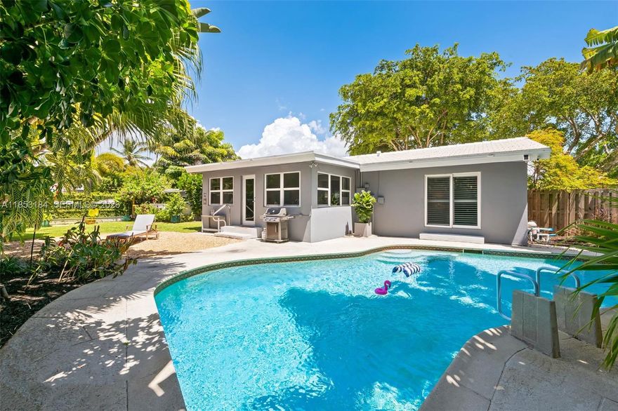 Welcome to serene, beautifully updated, chic Wilton Manors sanctuary. It offers the perfect blend of privacy, style and functionality. Step inside to discover a bright, open layout with abundance of natural lights, travertine marble & terrazzo flooring, high impact windows and doors, tastefully updated bathrooms. Flat tile roof replaced in 2015, A/C 2022, hot water heater 2024, fence 2020, Gourmet kitchen featuring high-end Viking appliances, island and cabinetry galore. This is perfect place for entertainment. The living area extends to a private backyard oasis w/ free shape pool surrounded by tropical lush greenery. It is hard to convey the beauty of the truly enchanting garden especially in nighttime. Great privacy w/11,329sf.ft. One car carport & shed offer extra space for storage.