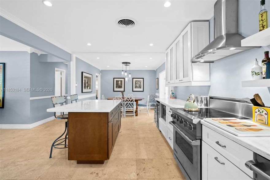 Welcome to a serene, beautifully updated sanctuary in the heart of Wilton Manors, offering the perfect blend of privacy, style, and functionality. Situated on an expansive 11,329 sq ft lot, this exceptional residence delivers refined indoor living and a truly enchanting outdoor retreat. Step inside to a bright, open layout filled with abundant natural light, elegant travertine marble and terrazzo flooring, high-impact windows and doors, and tastefully updated bathrooms. Major improvements include a flat tile roof (2015), A/C (2022), hot water heater (2024), and fence (2020), providing peace of mind for years to come. The gourmet kitchen is designed for entertaining, featuring high-end Viking appliances, a spacious island, and abundant custom cabinetry. The living space seamlessly extends to a private backyard oasis with a freeform pool surrounded by lush tropical landscaping. The garden transforms beautifully at night, creating a magical ambiance that must be experienced in person. A one-car carport and additional storage shed provide added convenience. This is South Florida living at its finest — private, elegant, and ideal for entertaining.