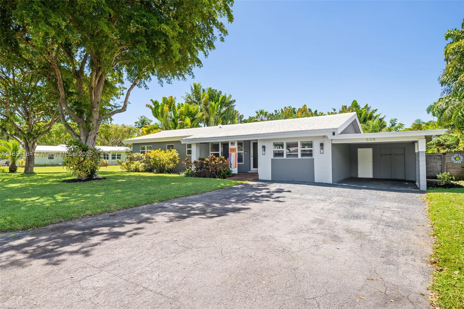 Welcome to serene, beautifully updated, chic Wilton Manors sanctuary. It offers the perfect blend of privacy, style and functionality. Step inside to discover a bright, open layout with abundance of natural lights, travertine marble & terrazzo flooring, high impact windows and doors, tastefully updated bathrooms. Flat tile roof replaced in 2015, A/C 2022, hot water heater 2024, fence 2020, Gourmet kitchen featuring high-end Viking appliances, island and cabinetry galore. This is perfect place for entertainment. The living area extends to a private backyard oasis w/ free shape pool surrounded by tropical lush greenery. It is hard to convey the beauty of the truly enchanting garden especially in nighttime. Great privacy w/11,329sf.ft. One car carport & shed offer extra space for storage.
