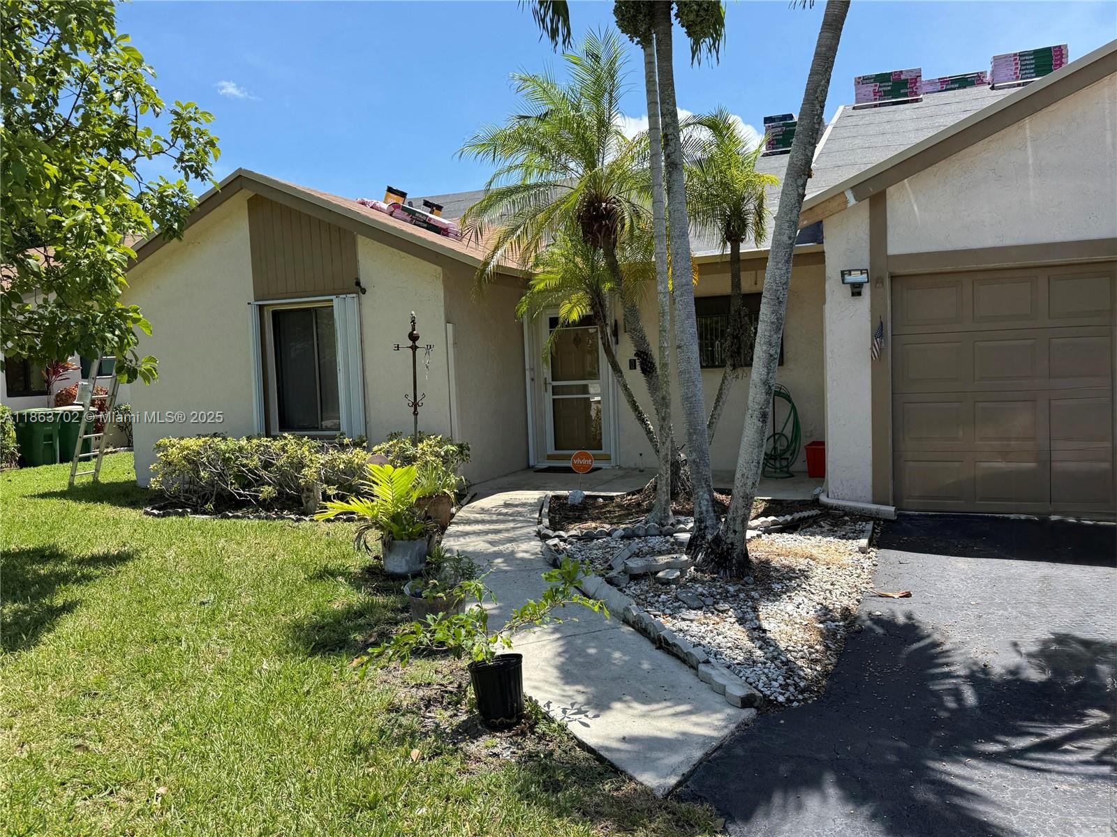 Located in a Quiet Community waterfront oasis in Tamarac's Edgewater neighborhood! This turnkey villa with a split floor plan the waterfront windows and a garage. This beautiful home is a 2/2 1332 Sq Ft. with a BRAND NEW roof 8/2025. single car garage, hurricane shutters, & screened in Patio with an insuated roof. Inside boasts, an open-concept design, vaulted ceilings, Luxury Vinal flooring, a remodeled kitchen with granit countertops, updated modern bathrooms. Clubhouse with a community pool and close to shopping, dining, and entertainment. Low HOA fee covers lawn care.