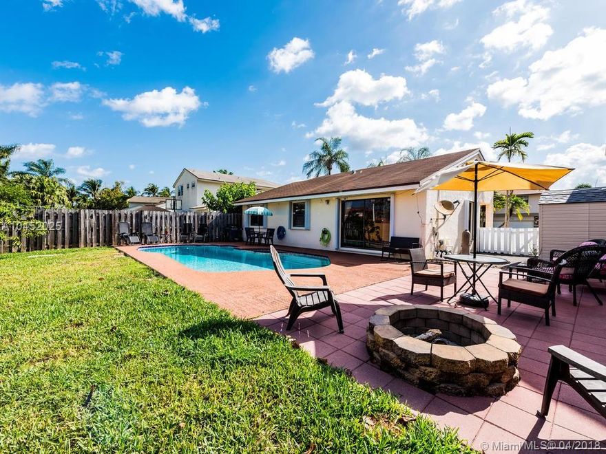 Make an offer on this beautiful 3 or 4 bedroom (4th bedroom is a well done garage conversion) pool home.  Great schools, super location!  4th bedroom, easily to convert back to garage.  Master suite is large, fully updated bathroom complete with a BIG whirlpool tub and walk in closet. Backyard paradise with free form pool, extra patio area for conversations around a fire pit plus an immaculate storage shed that creates extra space.  You will enjoy new and neutral tile floors throughout except the bedrooms which are carpeted. Large eat in kitchen and dining area for more formal occasions.  Hurricane?  No problems as windows are protected by fast 'n easy closing Accordion Shutters. First home or move down home, this is for you and the only thing missing are this home's proud new owners.