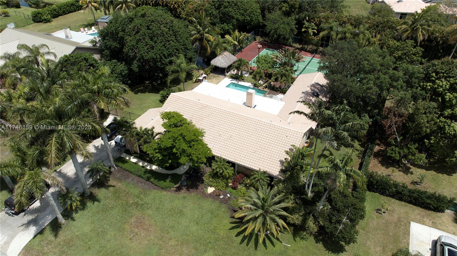 DON'T MISS THIS PARADISE OF A CUSTOM HOME THAT FEATURES 4 BEDROOMS, LUSHED LANDSCAPED BUILDERS ACRE, PRIVATE POOL, PRIVATE TENNIS COURT, SAUNA NESTLED AMONG INCREDIBLE MULTI-MILLION $$$ CUSTOM HOMES IN THE HEART OF DAVIE, THIS EXQUISITE HOME IS PRICED AGGRESSIVELY TO MAKE YOUR HOME DREAMS COME TRUE. INTERIOR FEATURES VAULTED CEILINGS, FIREPLACE, WET BAR, OPEN FLOOR PLAN, CUSTOM BUILT INS, AMPLE SPACE IN YOUR GREAT ROOM. EXTERIOR INCLUDES A TIKI HUT, COVERED SCREENED IN PORCH, POND WITH WATERFALL AND MORE TO ENJOY SOUTH FLORIDA LIVING AT ITS FINEST. NEAR EQUESTRAIN PARKS AND IN IDEAL LOCATION CLOSE TO ALL MAJOR INTERSTATES. THIS HOME IS PRICED TO SELL, THIS IS A GEM...