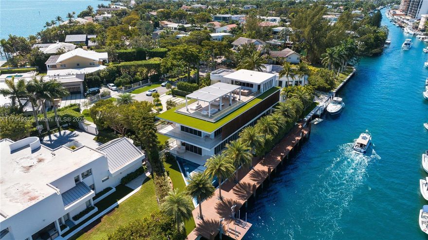 Discover unparalleled luxury in this 7,652 SF waterfront estate in a gated community, just 12 minutes from Bal Harbour Shops and 30 minutes from MIA & FLL. This 6-bed, 8-bath home blends modern elegance with resort-style living.

Enjoy 11’ ceilings, custom millwork, oak flooring, and a sleek Mia Cucina kitchen. The primary suite overlooks Biscayne Bay with a grand dressing room & spa bath.

Entertain on the rooftop deck with 270° views, kitchen & trellis lounge. Outdoors, indulge in a 70’ glass pool, sun deck, summer kitchen, and 2,000 SF dock with 163 FT of waterfront.

Additional highlights: jet ski lift, steel rooftop deck, poolside awnings, generator, putting green & 2-car garage. Offered fully furnished with $350K in Artefacto pieces, this turnkey retreat is a rare opportunity.