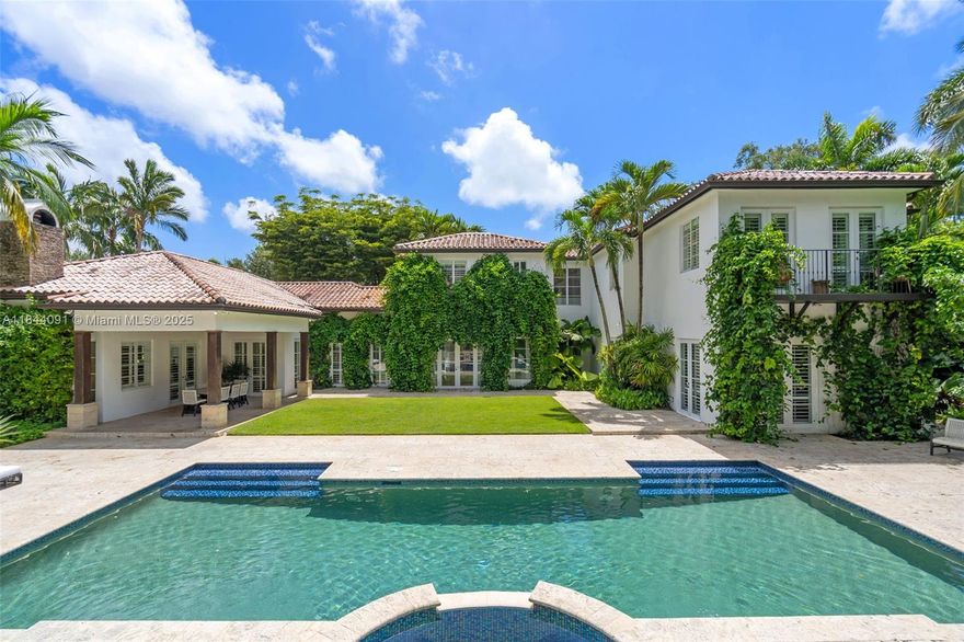 Discover this Mediterranean-style retreat on over 1 acre of lush, manicured grounds with a charming courtyard and a small fish pond. Designed for grand-scale entertaining and everyday living, it offers 2 primary suites—one up & one down—with generous closets, plus 4 additional ensuite bedrooms and a maid’s quarters with laundry. The open chef’s kitchen features Miele, Sub-Zero, commercial walk-in cooler, wet bar, and pantry. A summer kitchen with fireplace enhances indoor-outdoor living, while a 2-story guest house, currently used as an office and gym, complements the resort-style pool and spa. Smart features include Sonos sound, Lutron lighting, intercom, mosquito control, and landscape lighting. Three air-conditioned garages and a full-house generator complete this exceptional property.