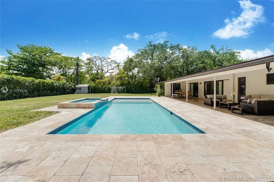 Renovated Pinecrest residence. This gorgeous, bright 4/2 home offers magnificent pool with hot tub, inviting covered patio and sits on generous private fenced backyard  of  17,597 SqFt. Excellent floor plan; Master bedroom & 2 bedrooms are on east side of house. A separate  bedroom is on the other side (ideal for guests or in-house maid). It is a L-shaped home, perfect for family fun & guests entertainment; kitchen, living, master and guest bedrooms open to patio, pool and garden. Many upgrades for your family to enjoy: heated pool & hot tub with saline system, all impact windows and doors, new roof, marble floors throughout, spacious multipurpose family room, kitchen with granite counter tops, neutral baths, exterior lights. Quiet street, very close to Palmetto schools. A must see