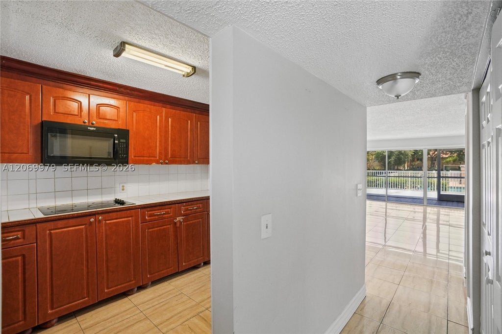Photo of 661 N University Dr #1-103, Pembroke Pines, FL 33024 (MLS # A12069979)