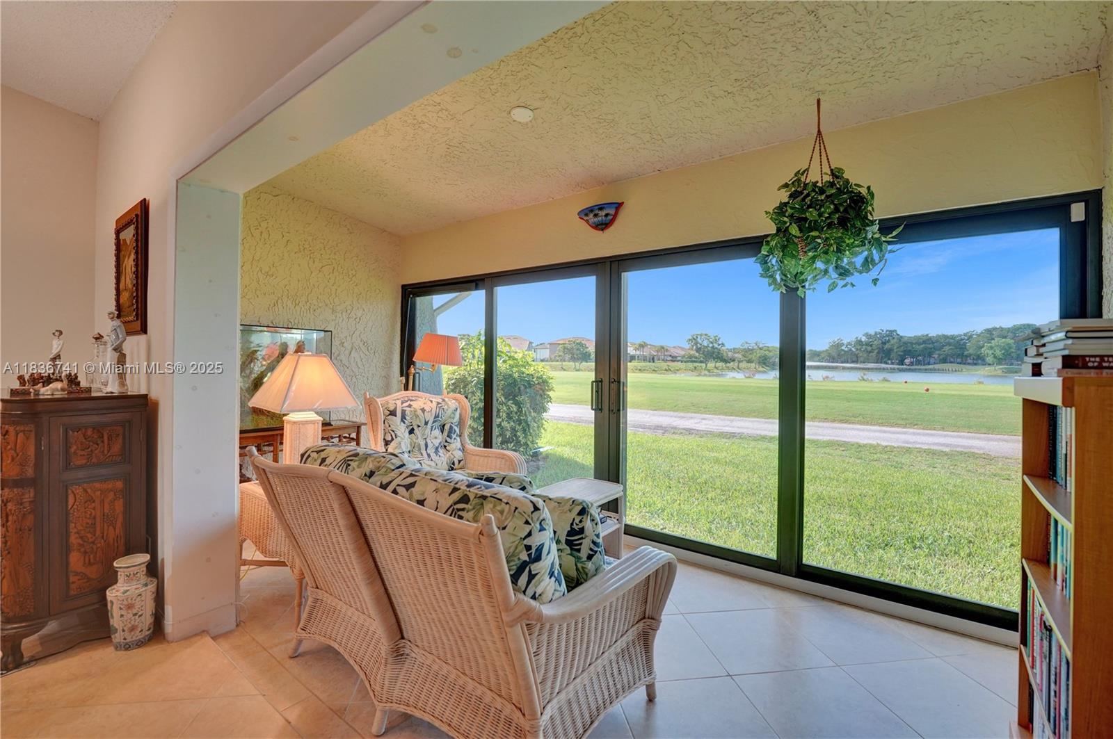 Welcome home to this bright & inviting 2-bed, 2-bath townhome in Waterford Isle at Woodmont Country Club. Enjoy the beautiful and peaceful golf course & lake views from your enclosed Florida sunroom & bedroom. With 1,318 sf of light-filled, open living space, the one-story unit features soaring skylights, spacious eat-in kitchen, wood cabinets and granite countertops. The primary suite has a custom walk-in closet while both bedrooms have ensuite bathrooms. Updates include a 2024 roof, impact doors & windows, 3-year-old AC & copper piping with a 2-car garage. 2 PETS permitted. The community pool is a short distance. This move-in ready home blends comfort, convenience, and peace of mind in a well-established neighborhood. Seller will OFFER a Closing Credit or Buy Down. Could be FHA Approved.