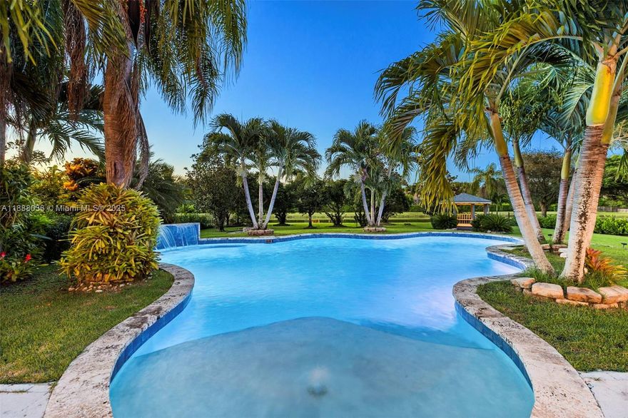 Discover refined living on a full acre in Kapok Village Estates, one of Davie’s most coveted communities. This 3,560 sq. ft. estate offers 4 bedrooms, 3 full baths, plus a versatile office/den. Designed for both elegance and comfort, the home features soaring ceilings, expansive living spaces, and a 3-car garage. Perfect for entertaining, it boasts a pool, heated spa, summer kitchen, and tranquil lake views. Surrounded by Davie’s equestrian charm and minutes from Long Key Nature Center, top schools, and major highways, the location offers both privacy and convenience. Seller is motivated and open to assisting with buyer needs, making this opportunity even more compelling.