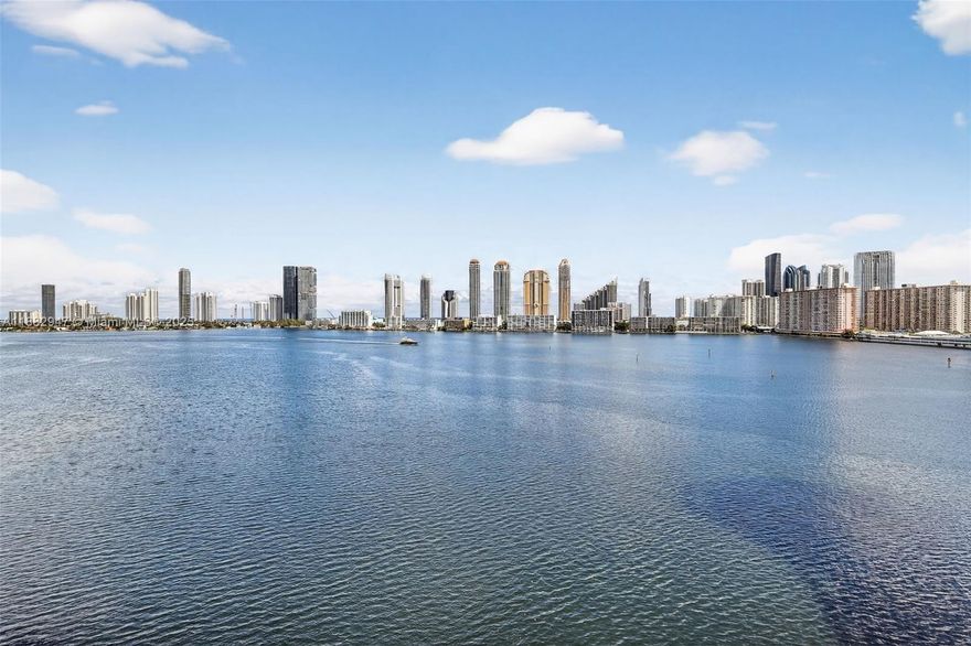 Stunning northeast corner wraparound residence with breathtaking Intracoastal and ocean views. Completely remodeled from A to Z with impact glass windows throughout. Permitted to create a true 3rd bedroom. Features an open ModulNova European kitchen with two-tone lacquer cabinetry and Gaggenau/Thermador/Miele appliances, including wine fridge. Cement-stone porcelain floors (2x4’), Legrand electrical switches, electric shades, and Fantini bath fixtures. Oversized master shower with rain system. Custom San Giacomo closets complete this luxurious, move-in-ready home. Experience the exclusive Williams Island lifestyle—resort-style amenities include a world-class spa, fitness center, marina, tennis & pickleball, fine dining, and on-demand shuttle service amid lush tropical beauty.