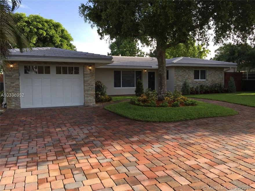 Stunning Residence with Ocean Access Canal & Water view. The home has been Completely Remodeled, there's not a single detail overlooked. Brand New Kitchen with Quartzite Counter Tops & Glass Tile Back Splash. New Kitchen-Aid appliances with Wine Cooler & dry bar.  Brand New Porcelain Floors upon an amazing Open Floor Plan. New bathrooms with Marble tile & Glass Back Splash. Master bath has Water Views & a Walk-in Closet. New Sea Wall and Boat Dock. Relax in your Italian Pergola Style with a Built-in Grill area. The Roof is Only 7 years Old.  New Electrical & Plumbing throughout.  All New Hurricane Impact Windows, Doors & Garage Door.  New Brick Driveway & Brick Patio in the Back for Entertainment.  One of a Kind Property, must see it to appreciate all the details & private spacious lot.