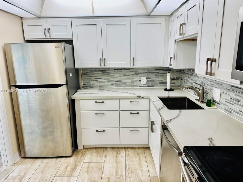 Photo of 2601 S Course Dr #409, Pompano Beach, FL 33069 (MLS # A11985400)