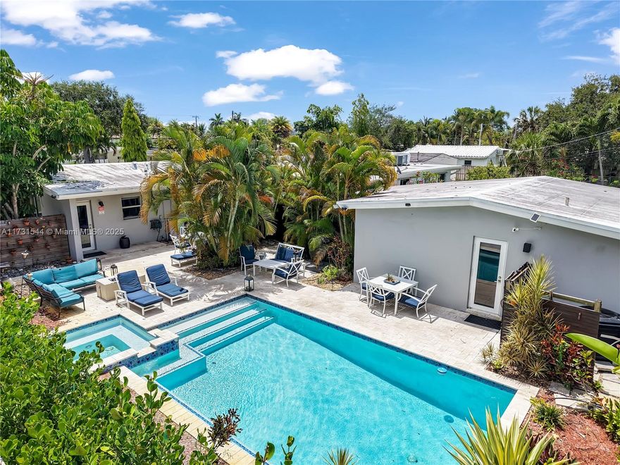 Excellent price improvement for a quick sale. Don't miss out on this tropical oasis. This amazing property consists of 2 bedrooms 1 bathroom main house and 1 bedroom 1 bathroom guest house. Each house has full kitchen and washer and dryer. Both homes have access to the pool with hot tub and a fire pit. Each house has it's own driveway. Great investment property. Was rented for $6,000 a month until April 16th,2025. Yearly lease. Substantially remodeled in 2017. Impact doors/windows. Pool 2016. Roof 2012. Most of the plumbing replaced in 2017.