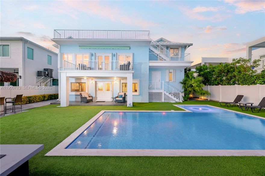 This canal-front pool home is an absolute beauty, combining timeless elegance with coastal sophistication. Renovated in 2022 and offered furnished or not, this home is filled with light-filled indoor and outdoor living spaces.Enter through the legal ground-level entrance into the indoor entertaining area, elevated above flood level and offering plenty of space for activities. Large windows and French doors lead to the fully turfed, low maintenance backyard, featuring a large heated and chilled saltwater pool, tiki hut outdoor kitchen, 70' composite deck, and a 20k-lb boat lift. Also on the ground level are a spacious half bath, laundry area, and temperature-controlled garage.Soaring stairs take you to the first bedroom with a full en-suite bath and an adjacent den that can serve as an exercise room or office, with backyard access.On the next floor, time spent here will be unforgettable, with window-lined walls and French doors with plantation shutters leading to the second-floor outdoor terrace. If you enjoy gathering around the kitchen, this space is for you, featuring a large countertop with unique Keys artwork, plenty of dining space, and a spacious living room all in one open area it will not disappoint. Another large bedroom with its own outdoor terrace and a remodeled bathroom can also be found on this level.Finally, head to the top floor, where the large primary bedroom with a spa-inspired bathroom awaits, along with private access to a very spacious roof deck.