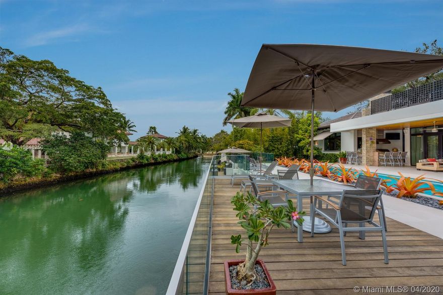 Beautifully designed Coral Gables waterfront home by award winning Ramon Pacheco. This exquisite residence was built in 2014 and features Cantilevered boat dock for a 36ft boat, heated & salt water pool and spa, large terrace with fully built out summer kitchen and surround sound system makes for amazing outside entertainment! Interior features includes custom built kitchen with built in TV,  soaring 14 ft ceilings and marble floors throughout. The Master suite is light-filled with views of the garden, canal and pool area, featuring a very large master bathroom with double sink with quartz counter tops, double shower, double closet and a morning kitchen with refrigerator. Landscape & irrigation system designed by renowned landscape and golf course Architect. Virtual tour available!