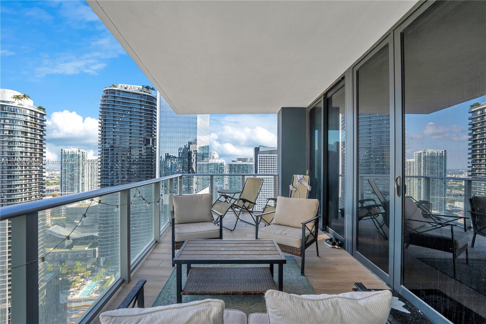 Experience elevated living in this spacious 1 bedroom + den, 1.5-bath residence. This elegant unit features wood-look tile flooring, 9-foot ceilings, custom-built closets, a sleek glass-enclosed shower, and top-of-the-line SMEG appliances, and includes 1 parking space. Enjoy world-class amenities in this resort-style building, with Rooftop oasis on the 50th floor, pool, and outdoor movie theater. Luxury wellness center with Hammam spa, hot/cold Jacuzzi, massage, sauna, and steam rooms. Enjoy the indoor heated pool, fitness center, basketball and racquetball courts, and running track. Last but not least, lounge with full kitchen, BBQ terrace, kids' playroom with bowling alley, virtual golf, ping-pong, and more. Just steps from Brickell City Centre, fine dining, and nightlife.