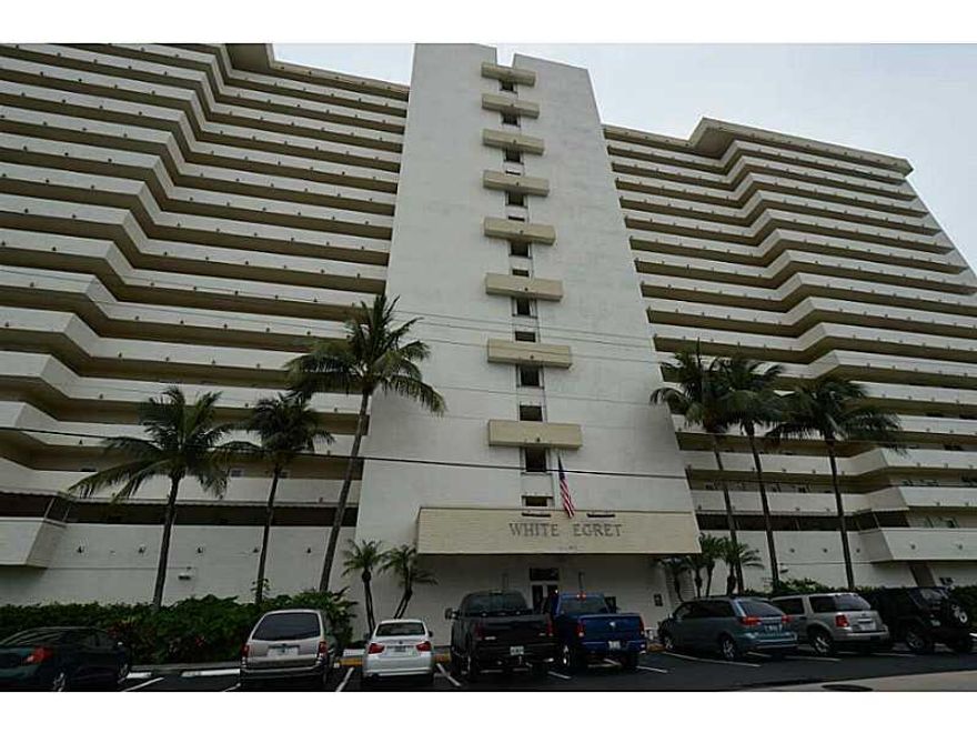 Completely Renovated 1 Bed 1.5 Bath condo with ocean/intra coastal views!  Wood Flooring Throughout! Granite Kitchen Counters with Stainless Appliances and Raised Panel Cabinetry Doors!  Kitchen Pass Thru w/Snack Bar from Living Room!  Both Baths Remodele d w/New Fixtures, Vanities and Lighting!  IMPACT WINDOWS!  Private Balcony!  Covered Parking!