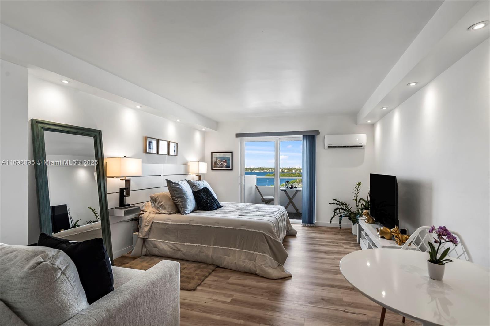 Wake up to sweeping views of Biscayne Bay from this beautifully renovated 10th-floor studio at Bayshore Yacht & Tennis Club in North Bay Village. The 444 sq. ft. space offers an open layout with floor-to-ceiling sliding doors and a private balcony that floods the unit with natural light. The kitchen is equipped with modern appliances, and the updated bathroom adds a sleek touch. This move-in-ready property also allows flexible short-term rentals (minimum one month), making it a great investment or seasonal retreat.