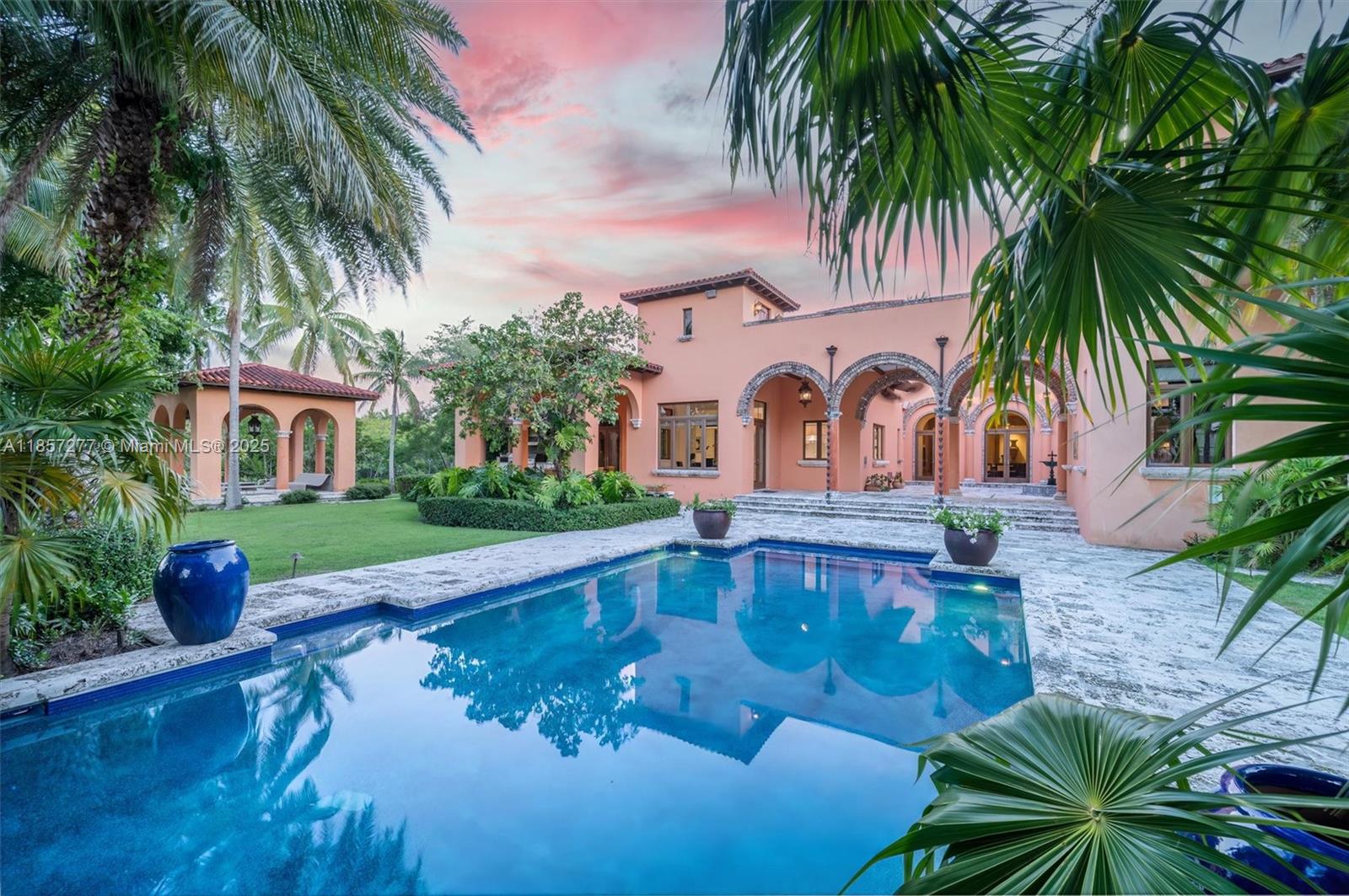 Introducing Villa De Casuarina, a Mediterranean-inspired estate in guard-gated Gables Estates. Spanning 11,500+ sq ft on a 38,161 sq ft lot, this private Riviera offers 8 bedrooms, 10 baths, 388' of water frontage, and timeless elegance. A grand foyer with soaring ceilings and Italian tiles leads to formal and informal living areas, a cedar wine cellar, theater, disco lounge, and a recently renovated chef’s kitchen featuring marble countertops, dual Sub-Zero refrigerators & freezers, and a Miele coffee stations. Outdoors greet you with manicured gardens, heated pool, terraces, summer kitchen, and dockage for 60’ yacht. North exposure for ideal light, with impact windows. Enjoy privacy, security, and close access to top schools, Coconut Grove, Coral Gables dining, true resort-style living