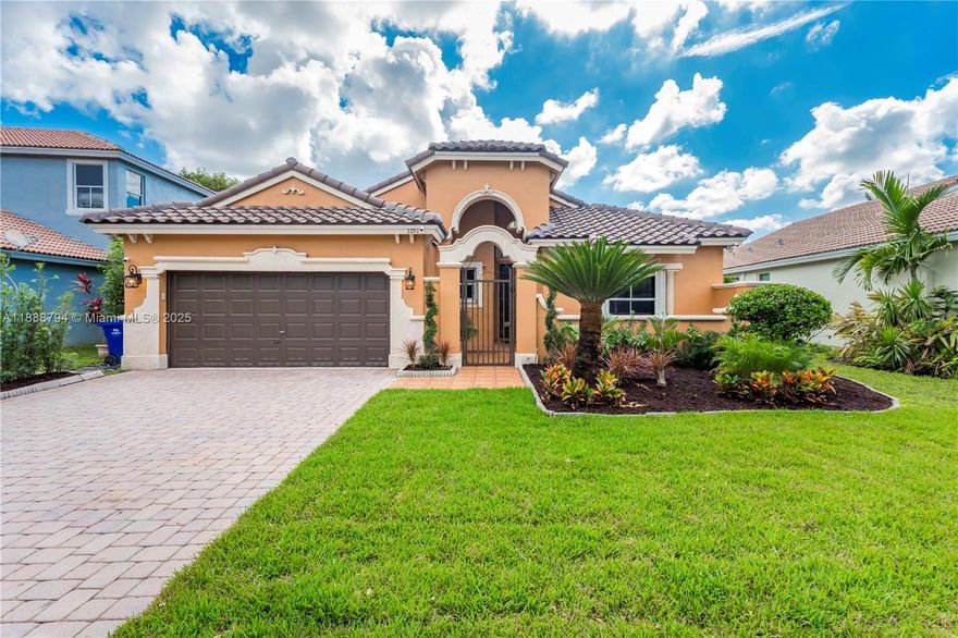 Enjoy stunning lake views from this beautifully updated home in the desirable Monaco Cove community! Featuring high ceilings and an open, airy layout, this property has been thoughtfully upgraded inside and out. Recent updates include a new S-tile roof (2024) with transferable warranty, new AC (2022), and brand new hardwood floors, fresh landscaping, and never-used kitchen appliances—all completed in 2025. Additional features include two updated bathrooms, accordion hurricane shutters, new garage cabinets and opener, upgraded ADT security with exterior cameras, and a Nest thermostat. Surrounded by mature tropical fruit trees—mango, papaya, avocado, soursop, guava, and more—this move-in ready home perfectly combines comfort, security, and peaceful lakeside living.