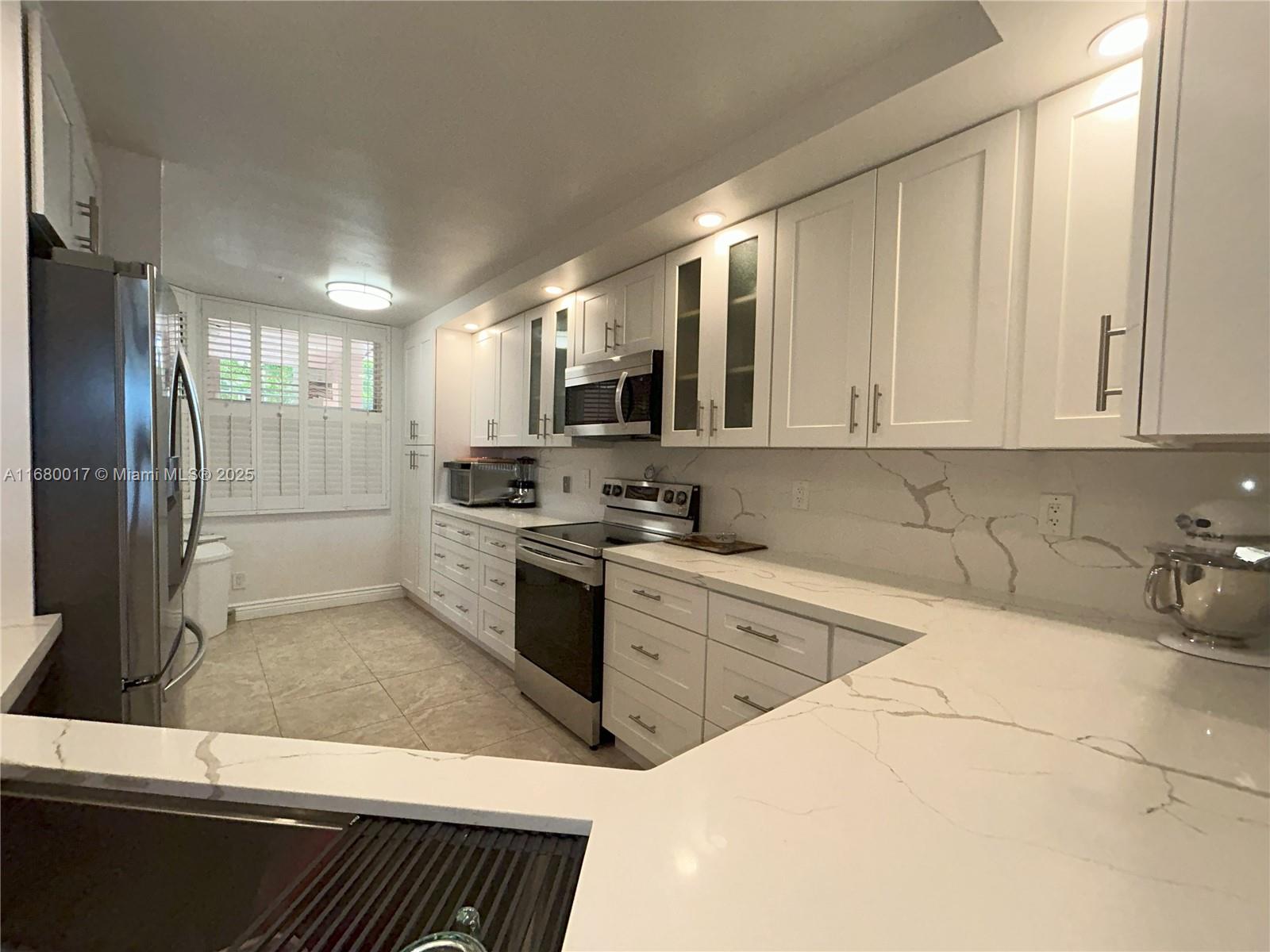 BEAUTIFULLY remodeled 3 bedroom 2 bathroom first floor unit (no need for elevators) WITH ASSIGNED PARKING SPOT DIRECTLY NEXT TO THE RAMP WALK-WAY AND A FEW STEPS TO THE UNIT. Best parking in the development. One of the largest units in the complex at 1590 sq ft, all tile, and one level. New kitchen, New bathrooms, huge dining room and living room, tons of closets all built out, New water heater, new full size washer / dryer, plantation shutters and blinds, split floor plan with large walk-in closet plus extra closet. Master bathroom has shower and separate walk-in tub with shower wand. Plenty of room to relax or entertain. Tons of amenities, pool, sauna, courtesy bus to Sawgrass mall, tennis, pickleball, billiards, clubhouse, BBQ. This area is NOT in a flood zone as per BCPA.