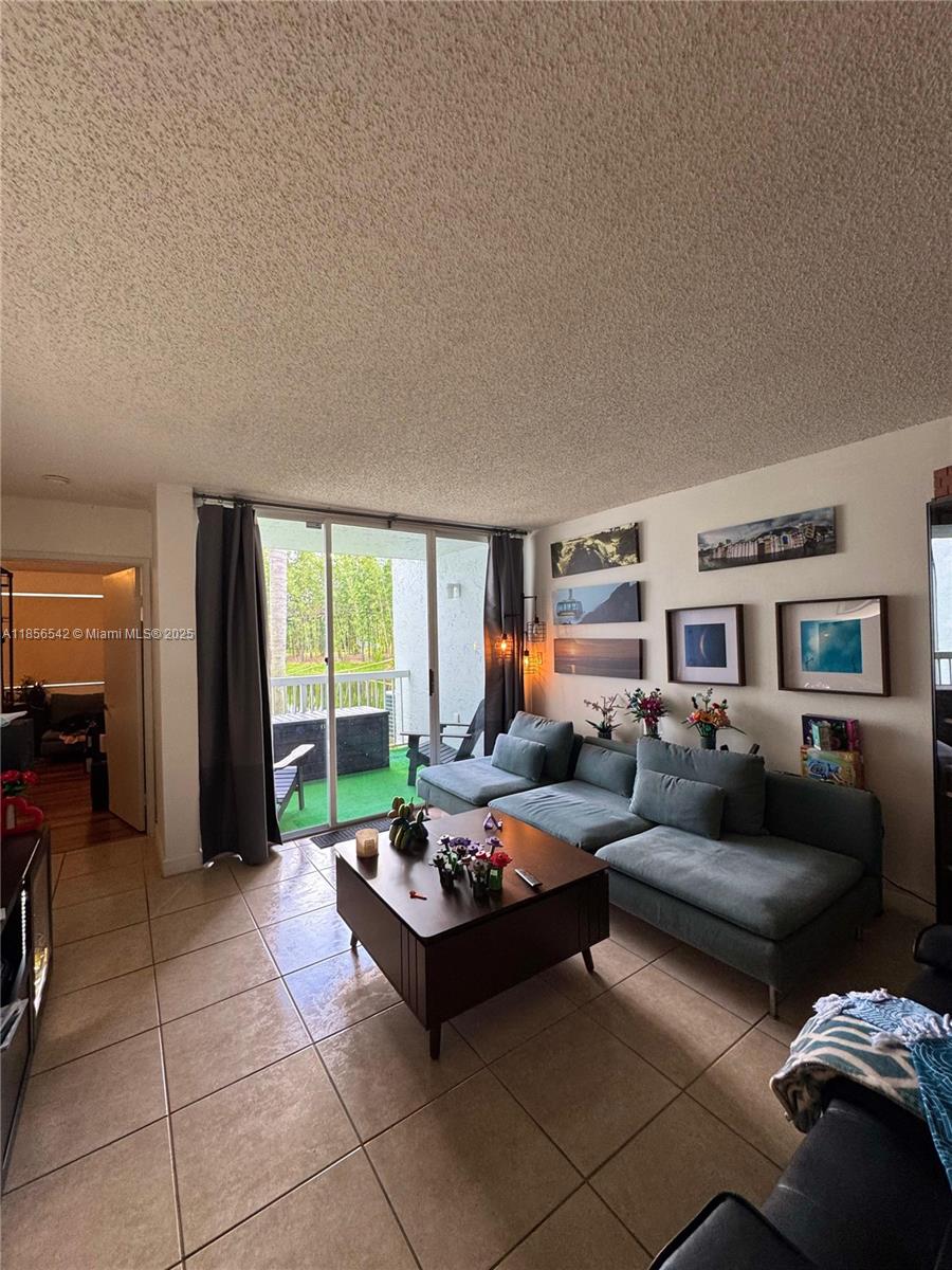 Ground level unit with beautiful garden and lake views! Brand new upgraded stainless steel appliances and all tiles. Washer and Dryer are inside the unit. This property is located in a Gated Community perfect for families, it is also very close to great schools and has easy access to highways. Great dining places located very close as well! Community has a pools, tennis courts, gym, and playgrounds!