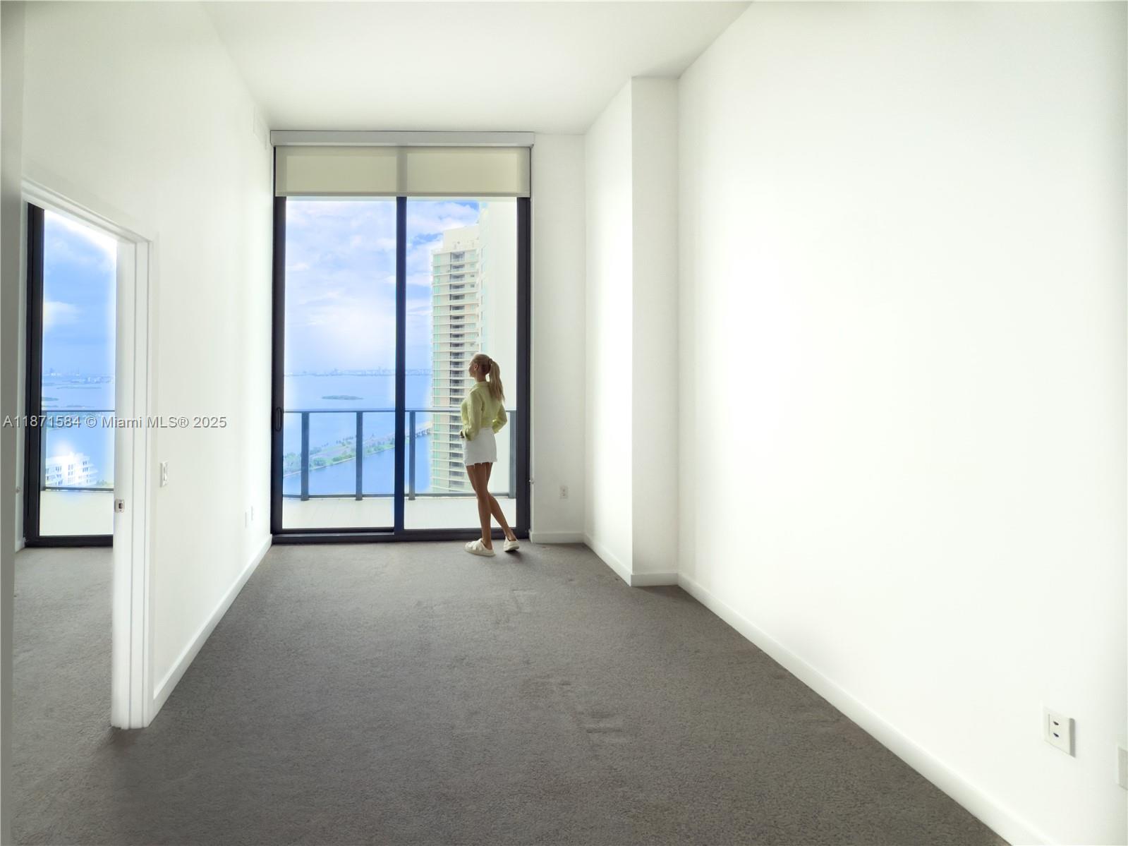 Welcome to Paraiso Bayviews in the highly sought-after Paraiso District. This stunning 40th floor residence is the only level with extra-tall ceilings and dramatic floor-to-ceiling windows. Natural light fills the one-bedroom, one and a half bath layout, with a modern kitchen, private balcony, and sweeping bay and city views. Paraiso Bayviews offers a rooftop pool and jacuzzi on the 60th floor, a second resort-style pool with spa, tennis courts, a fitness center, co-working spaces, and 24-hour concierge and valet. Steps from dining, shopping, and cultural attractions, this home blends design, amenities, and convenience. Be sure to view the video included to experience the soaring ceilings and incredible vistas.
