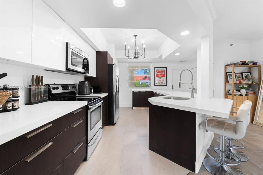 Enjoy stylish waterfront living in this fully upgraded 2-bedroom, 2-bath residence with stunning views throughout the community. The spacious primary suite offers a large walk-in closet, while the oversized second bedroom provides added flexibility.

The renovated kitchen features sleek cabinetry, stainless steel appliances, and modern flooring throughout. Two private balconies—one off the primary suite and one off the living room—invite seamless indoor-outdoor living.

Resort-style amenities include two heated pools, a fitness center, Pilates/Yoga studio, clubhouse, lighted tennis courts, and a BBQ pavilion. Pet-friendly and investor-friendly with rentals allowed up to 12 times per year.
Walk to Publix, dining, shopping, parks, and top-rated A+ schools—waterfront living at its best.