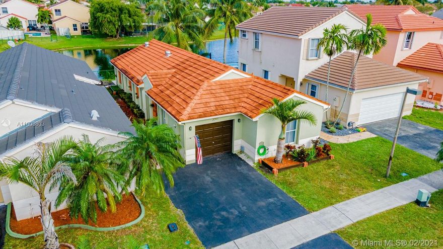 Amazing move-in ready, lakefront home in sought after Chapel Trail. This meticulously maintained 4 bed 2 bath home has a surplus of attractive features including additional living square footage. Vaulted ceilings & laminate flooring welcome you in. An updated kitchen w/ a cooking island w/ beautiful white & sparkly quartz countertops & like new SS appliances. Kitchen overlooks the lake. Spacious master bedroom w/ a modern design en suite bathroom & a relaxing spa shower. Additional features include: recessed & accent lighting, all bedrooms updated w/ modern doors. Exterior features include: imported 24x24 Italian patio tiles, full accordion shutters, serene lake & fruit trees. Community pool, low HOA fees, A rated schools, pet friendly, shopping, dining & parks nearby. Truly a must see!