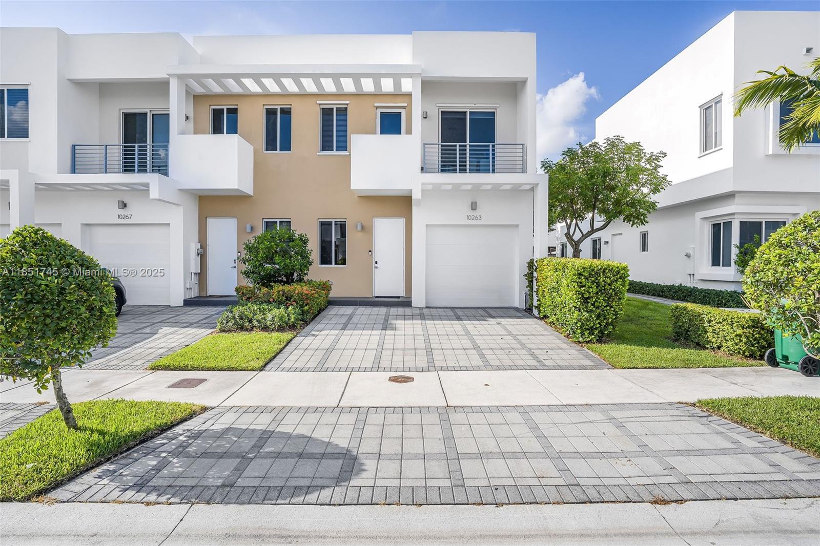 Two-story corner townhome located in the gated community of Neovita in Doral. Built with concrete construction and modern design, this home offers an open layout and a kitchen with contemporary finishes, a built-in wine cooler and recently updated amenities (e.g., dishwasher, faucet, garbage disposal, RO purifier). The exterior was recently painted, and a new garage door opener was installed. The home includes 4 bedrooms and 3 full bathrooms, with tile flooring on the first level and wood flooring upstairs. The backyard features artificial turf for easy maintenance, and the garage has been set up as a home gym with an EV charger. Bedrooms include dual-layer zebra blinds. HOA dues cover cable, internet, and access to the community clubhouse with a pool, gym, game room, kitchen, and more.