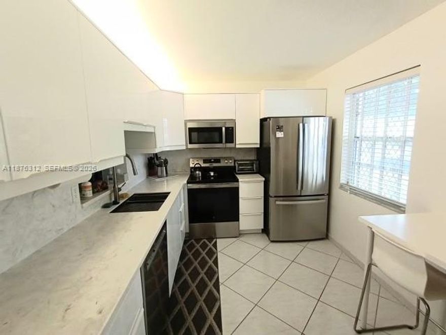 CORNER unit with extra windows and light and privacy!! Sleek with new appliances and eat in kitchen.
Large 2 bedrooms & 2 full bathrooms with bathtub & shower. WASHER AND DRYER IN UNIT (only allowed on the first floor). Paradise living! Screened private patio steps away from the lake, heated pool and clubhouse with internet, full kitchen & lots of activities, garden space outside back patio for plants. Assigned parking right outside your entrance. Shopping, walking trails, bike trails, one mile from the marina and beach. NEW AC, KITCHEN & APPLIANCES, BATHROOM VANITIES. Shutters, windows, front door and sliding doors are hurricane proof. Light & bright. Additional storage available. Close to Casino, Dania Pointe Mall, Beaches, State Parks, Shopping, Restaurants, Cafes, East of US1, FLL Airport and Cruise Port. Fast approval. 40-year certification done, NEW PAINTED BUILDING, NEW ROOF, stairs, walkways, elevator. Tons of guest parking. FULL RESERVES, LOW HOA!! 
3% down for conventional bank loans