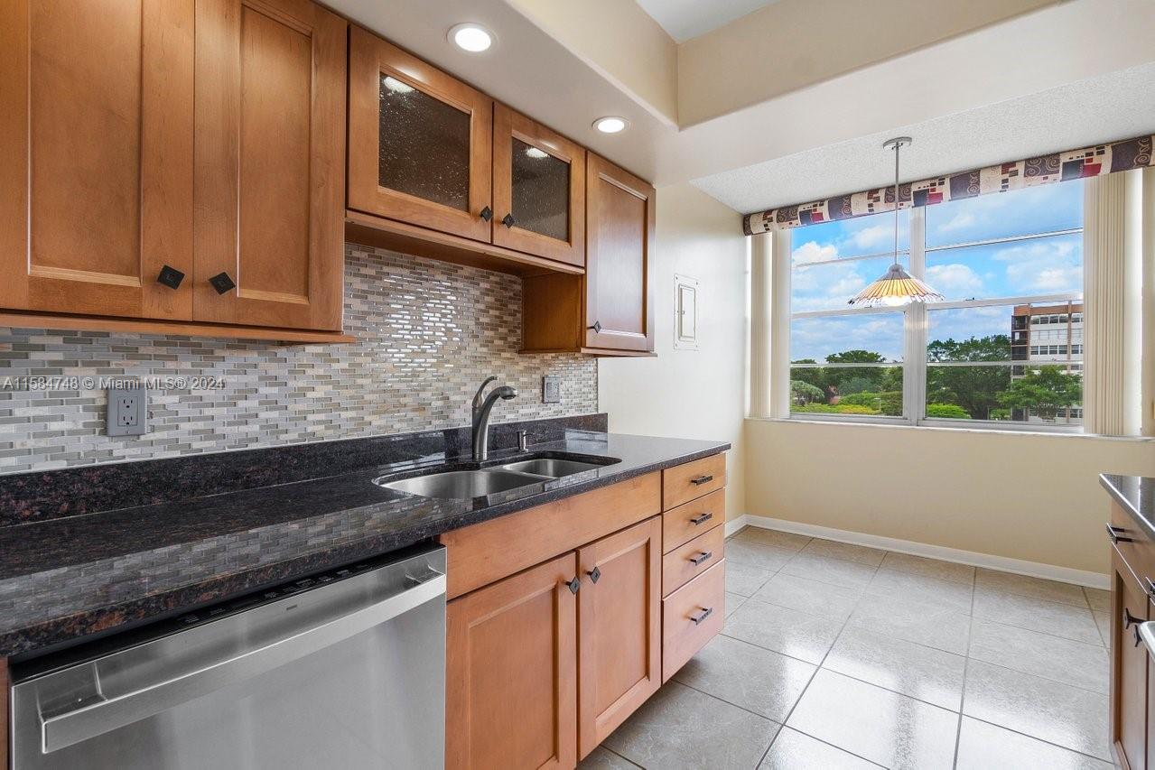 Spacious, open designed 2 bedroom, 2 bath corner unit in the 55+ desirable Park Place community in Pembroke Pines. Large primary bedroom w/ensuite updated bathroom w/ walk-in shower & walk-in closet. Kitchen & 2nd bath have been updated. Bamboo wood floors in the living-dining room & bedrooms, tile floors in the kitchen & bathrooms. This unit features lots of natural bright light in every room & the screened in balcony. A/C 2016, water heater 2018. Views include the golf course & pool. 1 assigned parking space. Resort style living w/ amenities such as 4 heated pools, tennis courts, golf course, billiards, club house, library, sauna, courtesy bus, walk/bike/jog path, social activities. Close to major highways, essential stores, restaurants, shops & more. 24/7 guard-gated community.