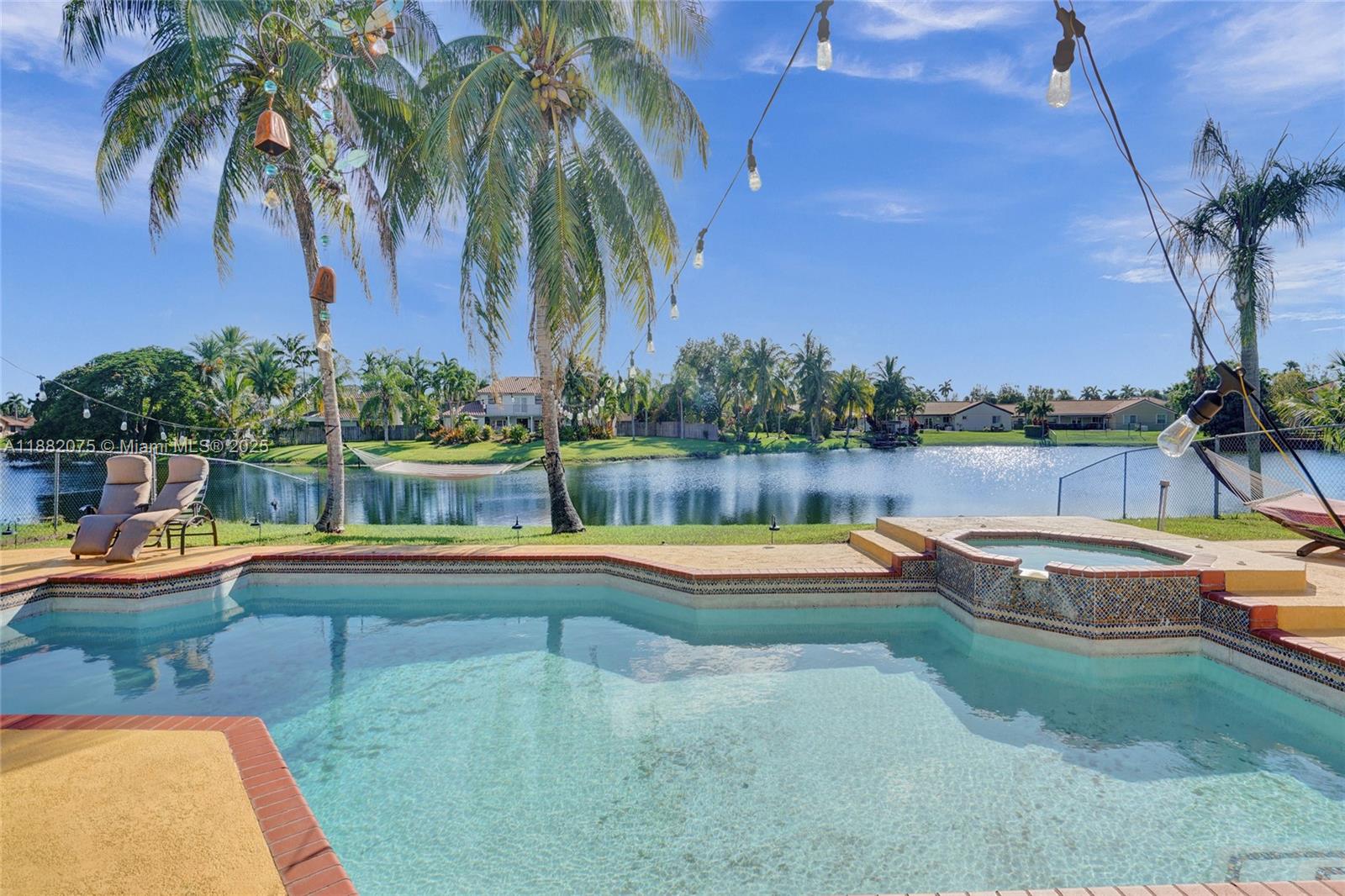 Lakefront living in this beautifully maintained 4-bedroom, 3.5-bath single-story home with a private pool & spa in
the desirable Hawkes Bluff community. It features a bright, open floor plan with Tile/Vinyl floor and freshly painted
interiors with new recessed lighting. The oversized primary suite offers two full bathrooms and large walk-in
closets, providing comfort & privacy. Enjoy peaceful 360° lake views from your backyard oasis, complete with a
sparkling Pool & Spa - ideal for relaxing or entertaining. Additional features include accordion shutters, dual-zone
A/C units, a 2-car garage & an extra refrigerator in the garage! Located close to top-rated schools, shopping,
dining, and I-75 highway, this home offers both tranquility and accessibility.