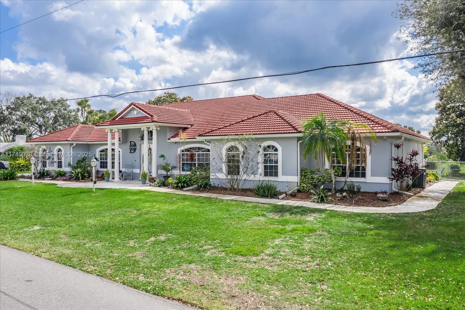 Rare opportunity to own your own one-of-a-kind home on a double lot. This magnificent house has vaulted ceilings, a huge gourmet kitchen with newer appliances, 2 ovens, 2 dishwashers, compactor, bar sink, granite counters and so much more. 3 of the bedrooms and the living room open to the lanai and pool area with phantom screens that open to the pool area with swim up bar. Beyond the patio is the fire pit and boat dock. Minutes to the 3700 acre sandy bottom lake. The home is equipped with solar panels, 3 car garage, updated security, irrigation and pool pump, new electrical panels, landscaping, and so much more. The neighborhood is quite friendly and great to take a walk or bike up to one of 2 local restaurants in the community. Make your appointment to see this beautiful home today.