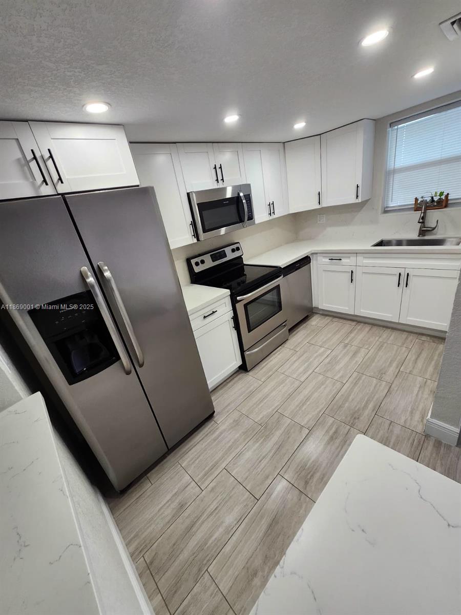 Recently remodeled with stainless steel appliances. Spacious and cozy two-story unit featuring 1 bedroom, 1 full bathroom with shower, and a half bath. The primary bathroom includes an updated double-sink vanity. Porcelain tile flooring throughout. Central A/C. Convenient parking located near the elevator. Washer and dryer in a large laundry room. Enjoy a lovely view of the creek and lake. Show Assist for showings!