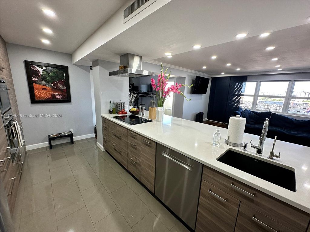 Photo of 401 Golden Isles Dr #1013, Hallandale Beach, FL 33009 (MLS # A11594668)