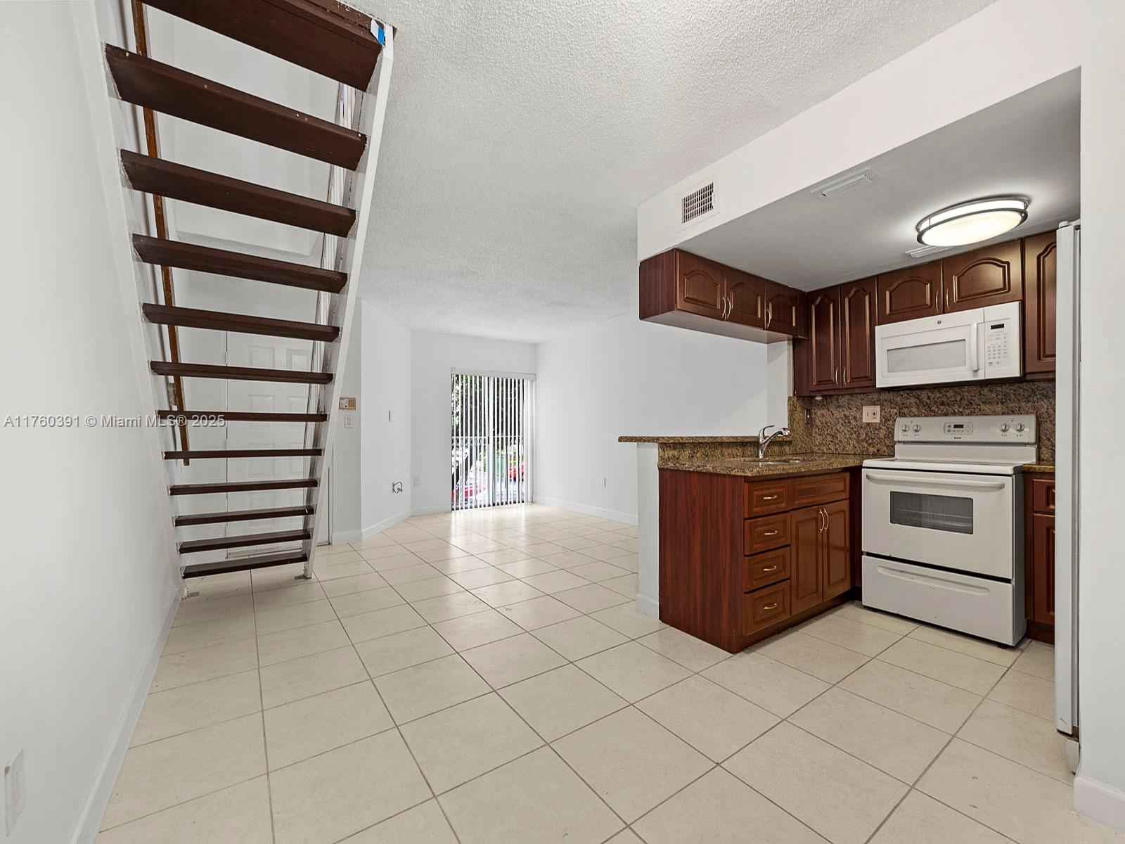 Newly installed impact windows and doors, new roof, freshly painted condo centrally located and in the gated community of Coral Pointe featuring 2 bedrooms and 2 full bathrooms with washer/dryer on second floor, and an open kitchen overlooking dining and living areas. 2 parking spaces included with one being assigned. Community features pool plus kid's pool and play area and on-site management. Very easy to show!