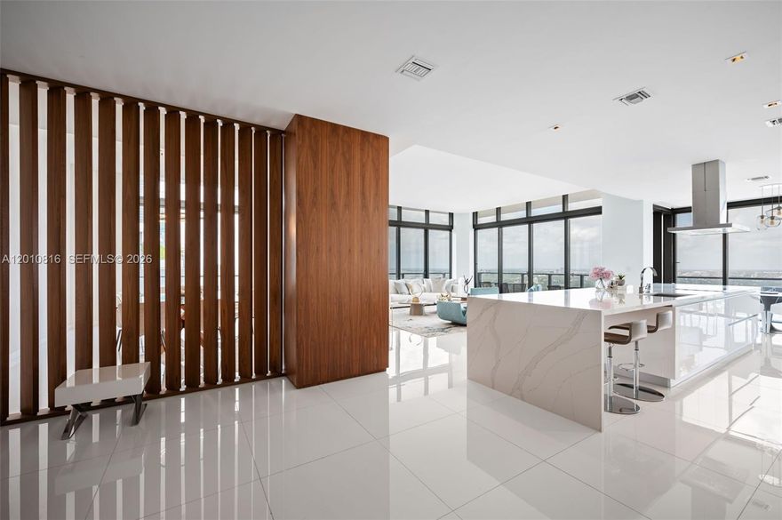 This is not just a residence—it is a statement penthouse at Rise, Brickell City Centre, where scale, design, and location converge to create a truly rare offering. Encompassing 4 bedrooms plus an enlarged den and 5.5 bathrooms, this exceptional corner home with 11' ceilings is defined by its grand proportions and uninterrupted water and city views, showcased from an extraordinary 1,035 square feet of wraparound balconies. Every detail has been curated for a refined, elevated lifestyle. Elegant porcelain flooring flows throughout, complemented by bespoke Italian cabinetry and a striking quartz island kitchen designed for both entertaining and everyday living. Spa-caliber bathrooms with sleek vanities and integrated automated shades add a layer of modern sophistication. Each bedroom is a private retreat with generous walk-in closets, while a full laundry room and separate staff’s quarters with a full bath provide seamless functionality without compromising discretion. With three assigned parking spaces convenience is effortlessly integrated into this distinguished home. Positioned above Brickell’s most prestigious destination for luxury shopping and dining, this penthouse represents a rare opportunity to own one of the most significant residences in the building and Brickell.