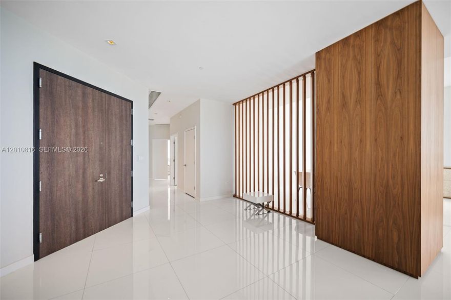 This is not just a residence—it is a statement penthouse at Rise, Brickell City Centre, where scale, design, and location converge to create a truly rare offering. Encompassing 4 bedrooms plus an enlarged den and 5.5 bathrooms, this exceptional corner home with 11' ceilings is defined by its grand proportions and uninterrupted water and city views, showcased from an extraordinary 1,035 square feet of wraparound balconies. Every detail has been curated for a refined, elevated lifestyle. Elegant porcelain flooring flows throughout, complemented by bespoke Italian cabinetry and a striking quartz island kitchen designed for both entertaining and everyday living. Spa-caliber bathrooms with sleek vanities and integrated automated shades add a layer of modern sophistication. Each bedroom is a private retreat with generous walk-in closets, while a full laundry room and separate staff’s quarters with a full bath provide seamless functionality without compromising discretion. With three assigned parking spaces convenience is effortlessly integrated into this distinguished home. Positioned above Brickell’s most prestigious destination for luxury shopping and dining, this penthouse represents a rare opportunity to own one of the most significant residences in the building and Brickell.
