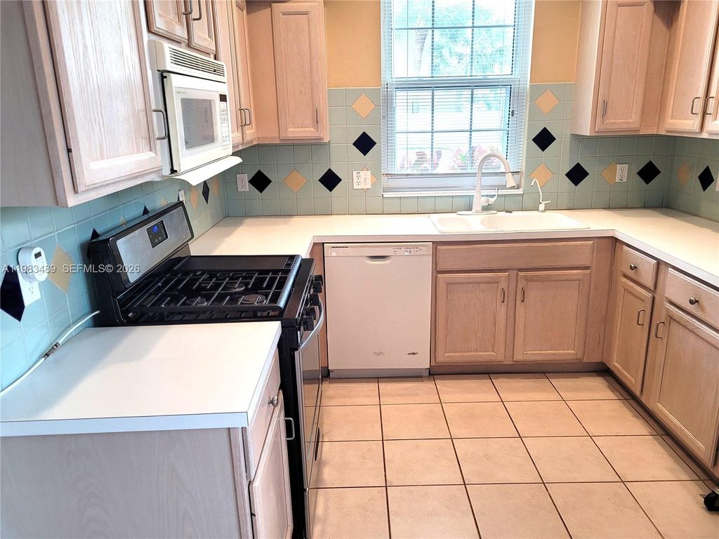 Photo of 5823 Plum Harbor Cir, Tamarac, FL 33321 (MLS # A11983489)