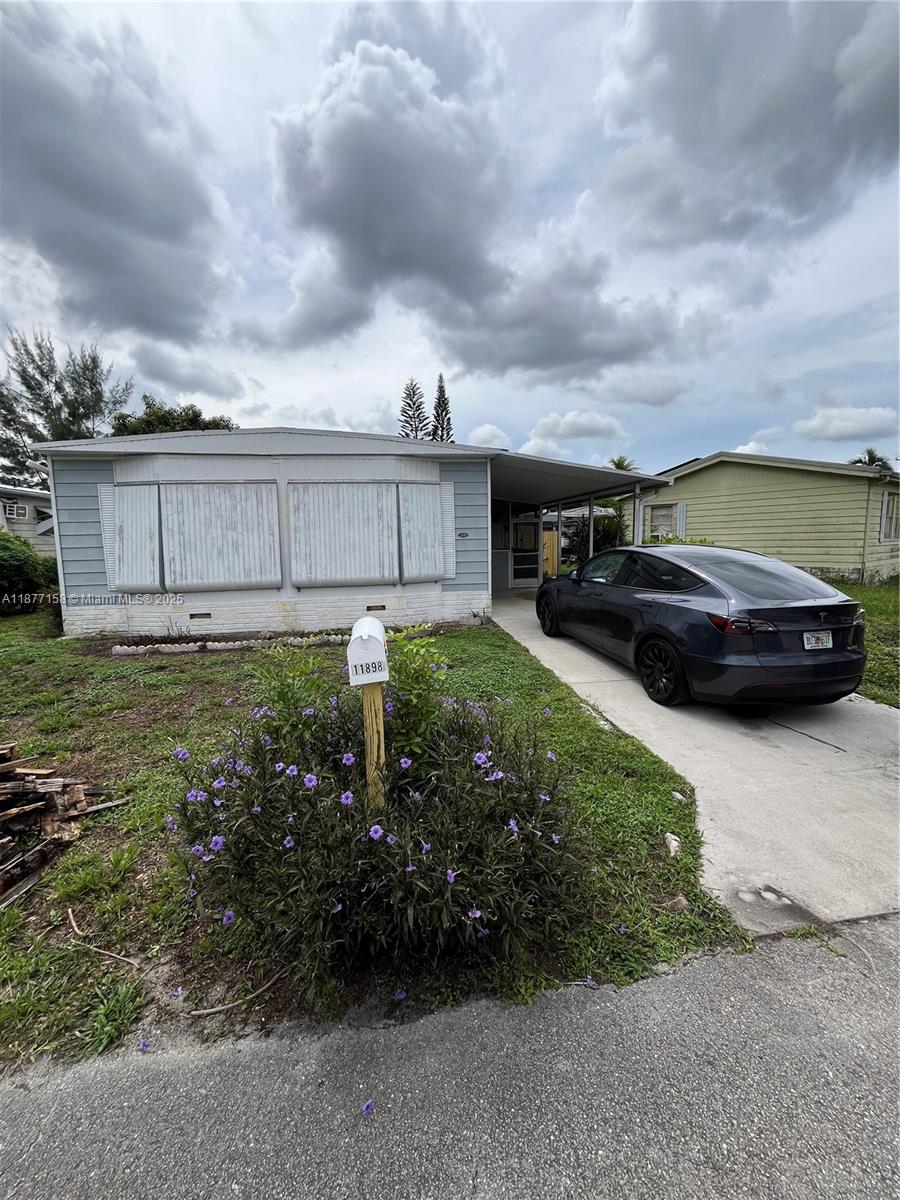 Clean, large interior. One covered carport space, and additional parking in driveway.Spacious 2/2 in a quiet community. No association. Landscaping is covered. Act fast, this one wont last.