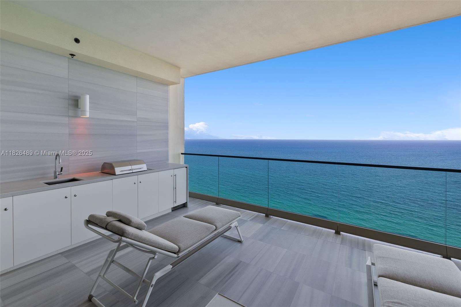 Oceanfront “Vecchio” residence at The Estates at Acqualina, designed by DKOR Interiors. Flow-through layout with 4 bedrooms, 5 bathrooms, and a den. Features include spacious great room and family room, two terraces with ocean and Intracoastal views, Miele appliances, and La Cornue gas range. Smart home automation with electric shades and blackouts. Primary suite includes dual bathrooms with onyx finishes. Full-service building with amenities such as spa, theater, ice-skating rink, bowling alley, Avra restaurant, and more. Offered furnished with Fendi, Poltrona Frau, and B&B Italia pieces. $8.5M.
